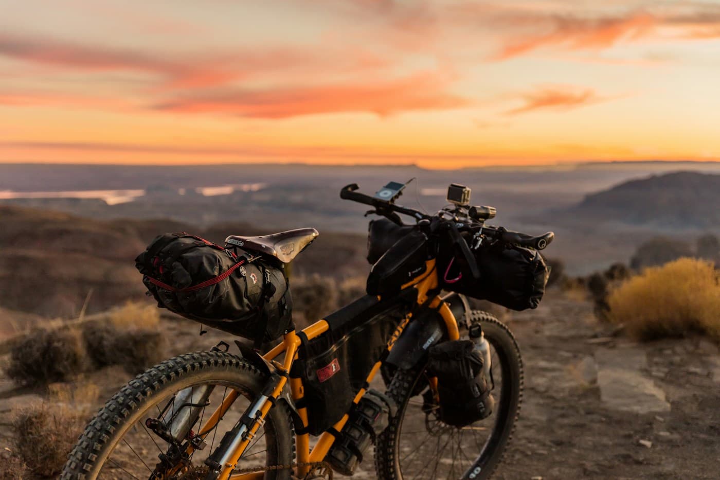 Mountain biker riding over warm sandstone terrain